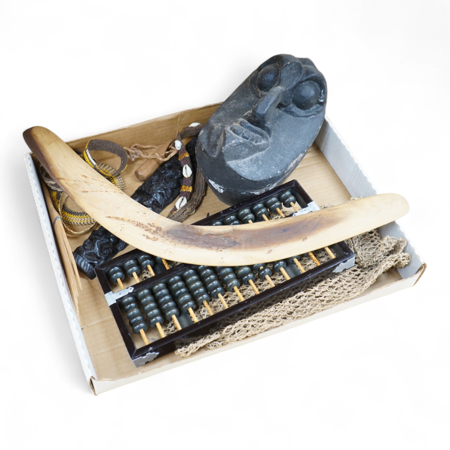 A collection of tribal carvings, straw bags, an abacus- 29cm wide and boomerang